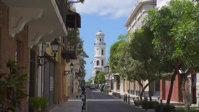 Dominican Republic, Santo Domingo - August 7, 2021: Arzobispo Merino street and Palacio Consistoral tower, most popular tourist destination in the Colonial Zone