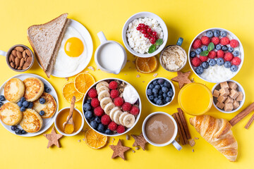 The continental breakfast is captured from above, top view. Coffee, croissants, granola, Belgian waffles, honey, jam. Layout with free text space, copy space