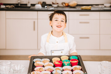 baking cookies. Child bakes cupcakes at home 