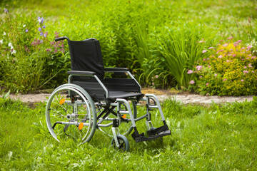 Empty wheelchair in the garden or in the park.