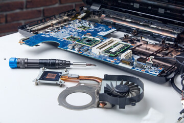 disassembled laptop, computer workshop, cooling system, screwdriver