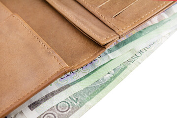 Leather wallet. Banknotes of 100 zloty, Polish money, on a white background