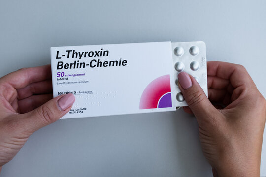 Tallinn, Estonia - July 16, 2021: Hands holding L-Thyroxin tablets by Berlin-Chemie Menarini for thyroid. Pharmacy and medicine concept.