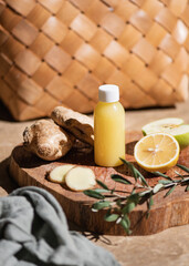 Obraz na płótnie Canvas Ginger citrus shot fresh immune boosting juice in bottle