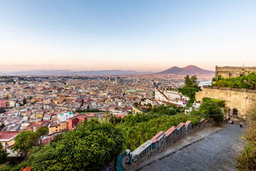 Napoli, Italy - July 11, 2021: Bay of Napoli and Vesuvius volcano in background at sunset in a summer day in Italy, Campania