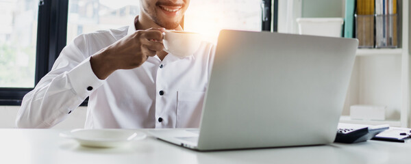 freshy businessman drinking coffee in morning and working on laptop