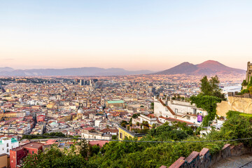 Napoli, Italy - July 11, 2021: Bay of Napoli and Vesuvius volcano in background at sunset in a summer day in Italy, Campania