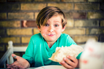 Happy, and messy, boy eating a taco