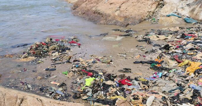 Pollution garbage trash beach Cape Coast Ghana Africa. Ghana West Africa on the Atlantic ocean. Filthy pollution, trash, garbage and waste wash up on shore. Sandy beaches. Summer vacation.