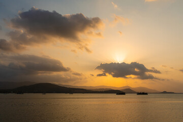 Naklejka na ściany i meble Sunset over the bay with fishing boats