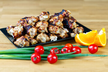 meat fillet and vegetables. grilled chicken meat served with fresh vegetables on wooden table. home party bbq