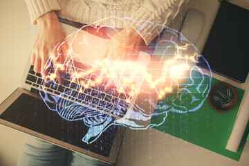 Double exposure of woman working on computer andhuman brain hologram drawing. Top View. Ai concept.