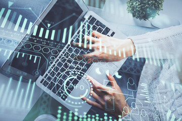 Double exposure of woman hands working on computer and tech theme hologram drawing. Top View. Technology concept.