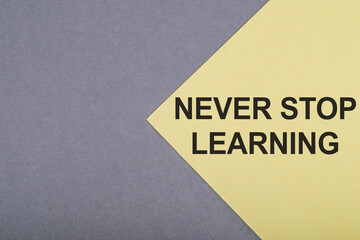 NEVER STOP LEARNING text on gray-yellow background.