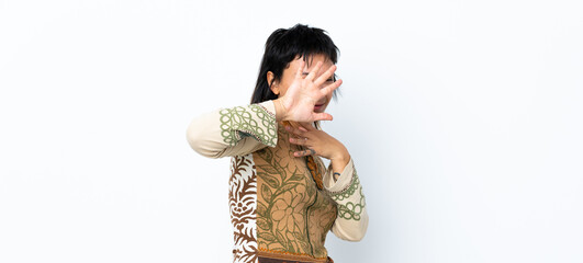 Young Uruguayan girl over isolated white background nervous stretching hands to the front