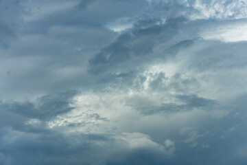 Ominous dark blanket of cumulus rain cloud vibrant blue sky. Weather conditions and climate detail background.