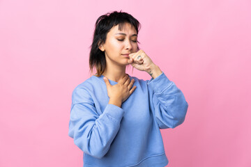 Young Uruguayan woman over isolated pink background coughing a lot