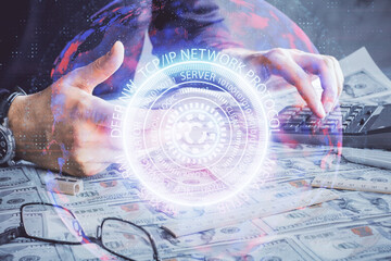 Double exposure of man's hands holding and using a digital device and tech theme hologram drawing. Technology concept.