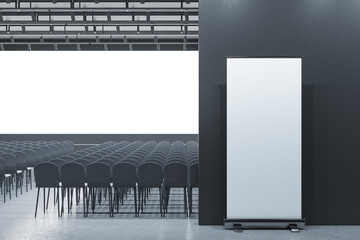 Modern grey auditorium with seating and empty screen with mock up banner for your advertisement....