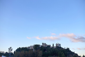 View of the castle of monda on top of the mountain at sunset