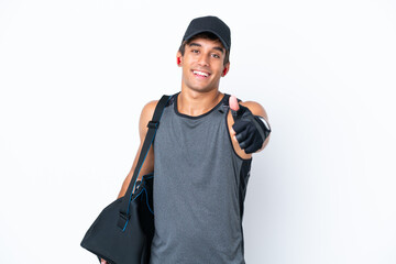 Young sport caucasian man with sport bag isolated on white background with thumbs up because something good has happened