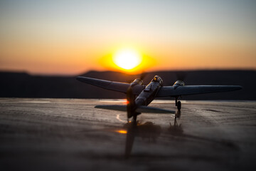World war ii fighter plane at sunset or dark orange fire explosion sky. War scene. German figher at sky. Selective focus