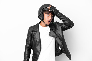 Young man with a motorcycle helmet isolated on white background doing surprise gesture while looking to the side