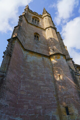 Fototapeta na wymiar a beautiful hand built 13th Century stone church in the Wiltshire UK Cotswold village of Castle Combe
