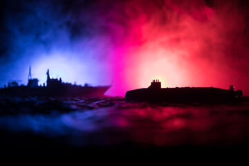 Silhouettes of a crowd standing at blurred military war ship on foggy background. Selective focus. Passengers try to escape. Protest of people