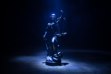 Law concept. Miniature colorful artwork decoration with fog and backlight. The Statue of Justice -...