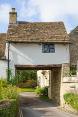 Fototapeta na wymiar pretty Archway cottage over a road in the Wiltshire UK Cotswold village of Castle Combe