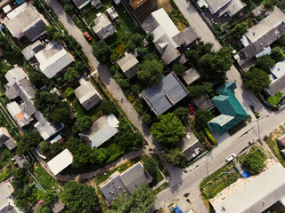 Aerial view of suburb of European city. Green neighbourhood on a sunny summer day. County living....