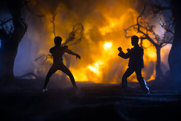 Karate athletes fighting scene on boxing ring with red ropes. Character karate. Posing figure artwork decoration. Sport concept. Decorated foggy background with light. Selective focus