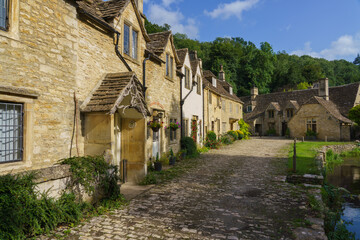 Fototapeta premium beautiful 16th / 17th century cottages on Water Street in the scenic Wiltshire UK Cotswold village of Castle Combe