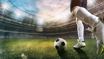 Football scene at the stadium with close up of a soccer shoe kicking the ball - obrazy, fototapety, plakaty
