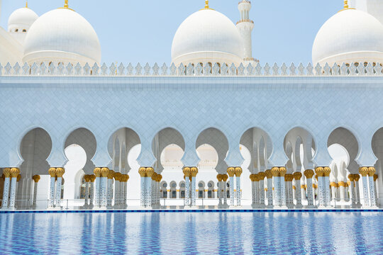 exterior of Sheikh Zayed Grand Mosque reflected on water surface in abu dhabi, united arab emirates