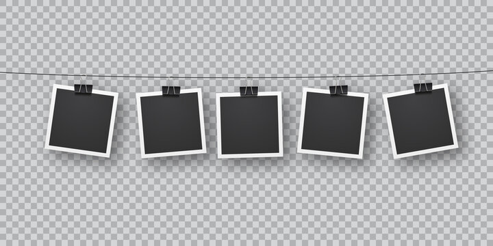 Realistic retro photo templates suspended on metal clips in a row.