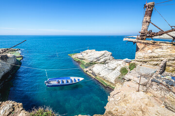 Fototapeta premium Boat next to famous Pigeon Rock in Raouche district of Beirut capital city, Lebanon