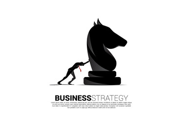Silhouette of businessman push knight chess piece. concept of business strategy and marketing plan