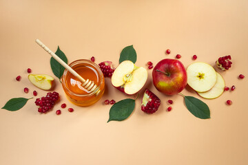 Traditional Jewish holiday New Year. Happy Rosh Hashanah. Apples, pomegranates and honey on yellow background. Place for your text.