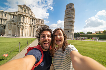 Travel tourists friends taking photo selfi with smartphone in Pisa, Tuscany. happy couple in love...