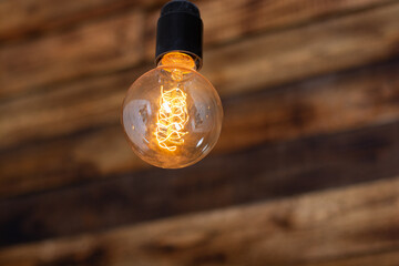 round retro edison lamp on a wooden background.