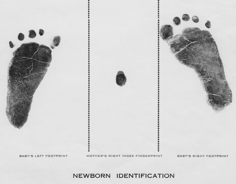 Footprint made with ink on paper of both feet new born infant girl