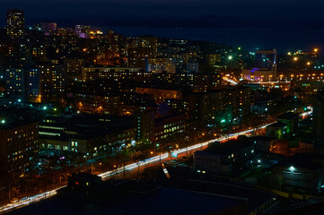 Fototapeta na wymiar Aerial view of the night city of Vladivostok, Russia. Car traffic.