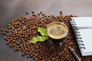 Americano Espresso coffee beans on cup topview on dark background