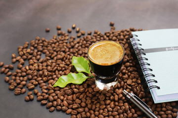 Americano Espresso coffee beans on cup topview on dark background