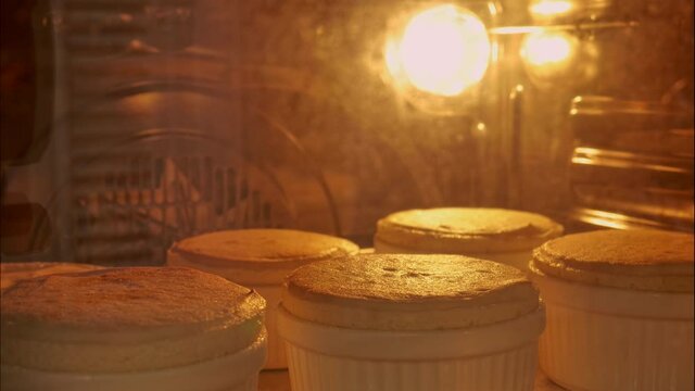 4K Timelapse of baking pastries in bakery oven with high temperature at the kitchen. Homemade of baking process of souffle in the oven.