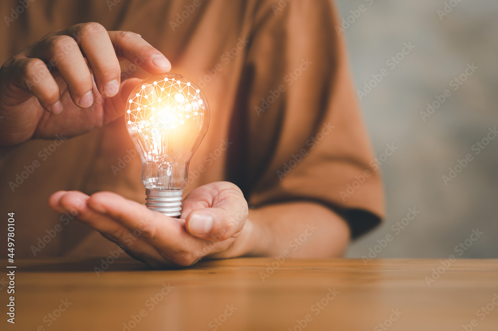 Aufkleber Innovation. Hands holding light bulb for Concept new idea concept with innovation and inspiration, innovative technology in science and communication concept.