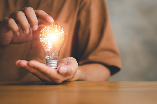 Innovation. Hands holding light bulb for Concept new idea concept with innovation and inspiration, innovative technology in science and communication concept.