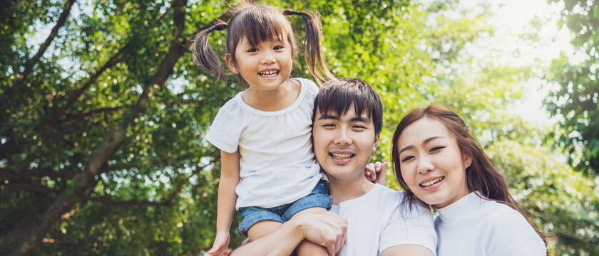 Banner photo of portrait of  happy asian family In garden. asian people, family, relationship and happy family concept